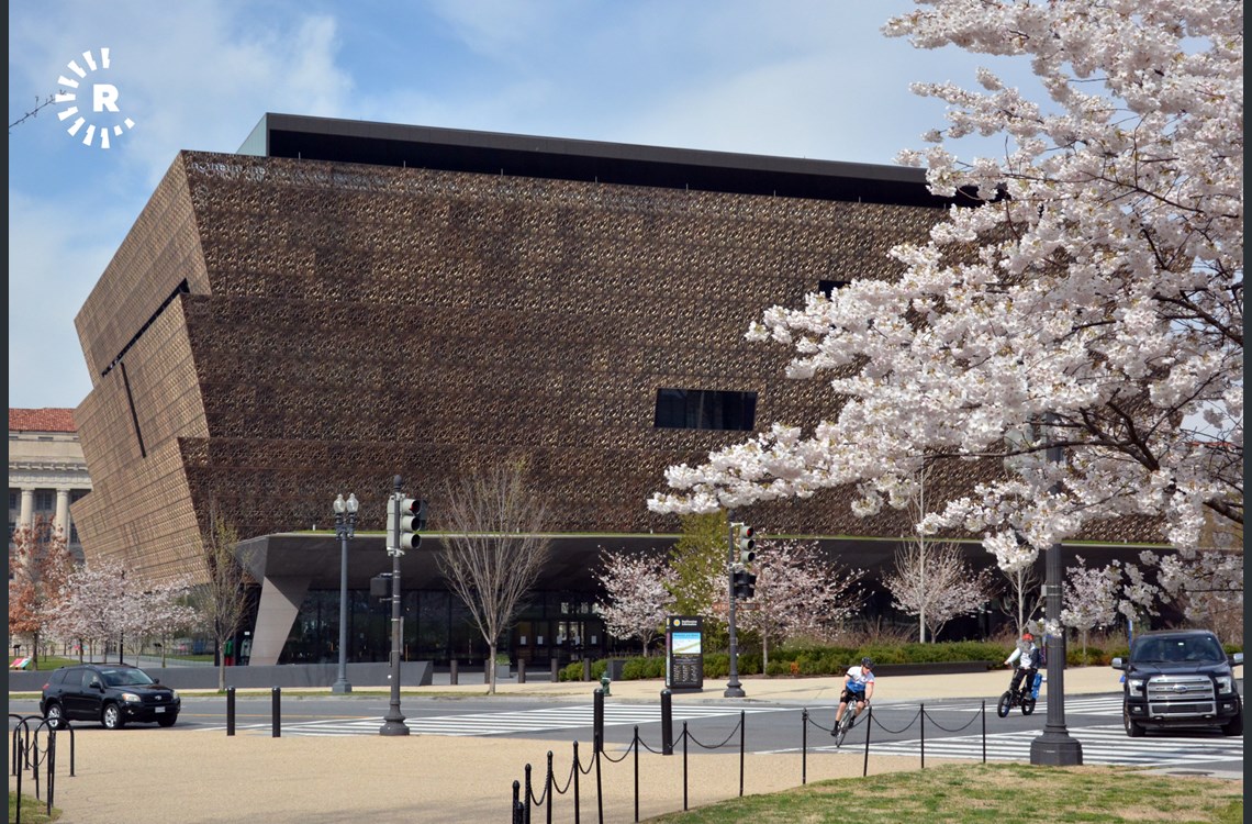 Cyclists turn the corner around the Smithsonian National Museum of African American History and Culture during Cherry Blossom 